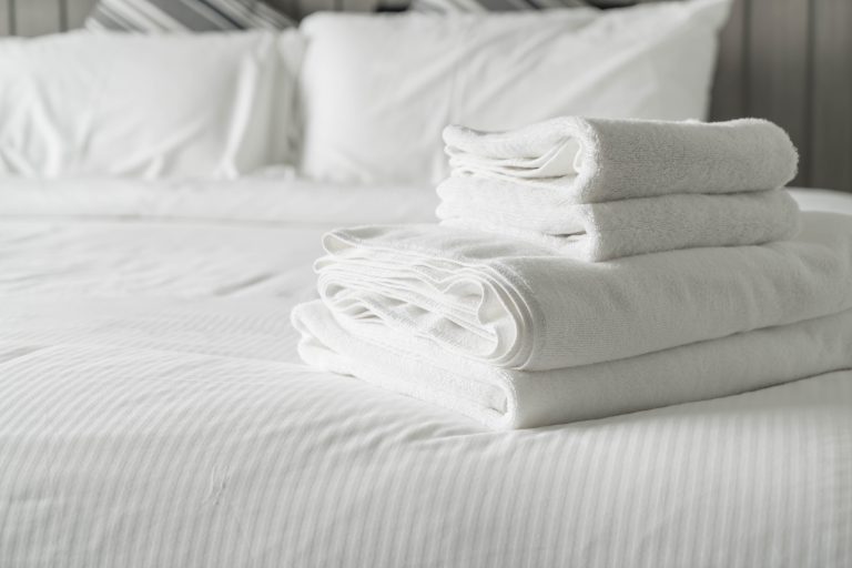 White towel on bed decoration in bedroom interior - Vintage light Filter